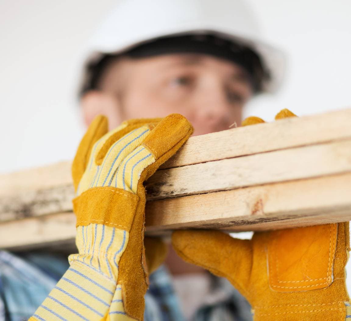 Man moving lumber